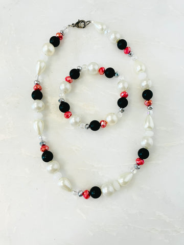 red, black and costume pearl necklace and bracelet. It is a matching set