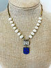 freshwater pearls and vintage chain make up this necklace.  Rhinestone element and a blue medal hangs from the necklace