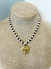 Swarovski crystal gold bee pendant hangs from a necklace of alternating garnets and freshwater pearls 