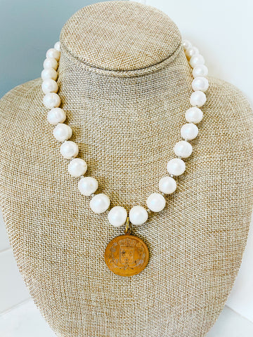 white freshwater pearls and brass colored french coin pendant 