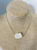 back of one white baroque pearl and antique gold lined bead necklace 