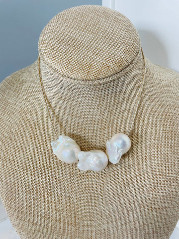 three white baroque pearls and antique gold lined bead necklace